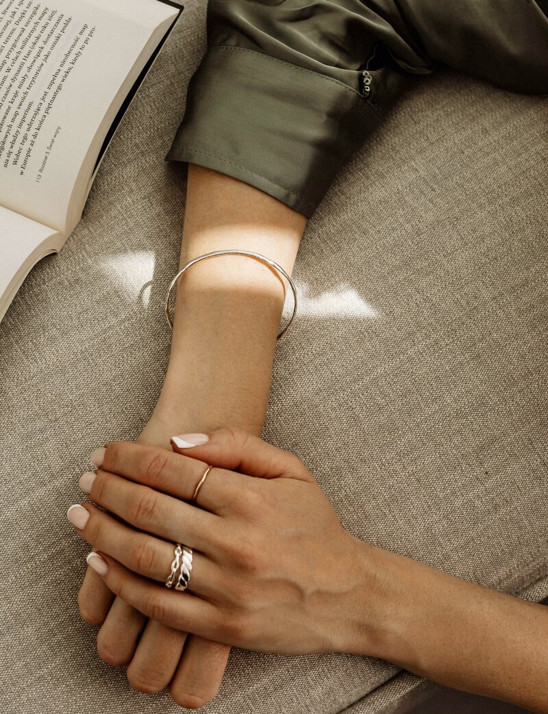 Professional woman's hands resting calmly, representing poise and readiness for career advancement