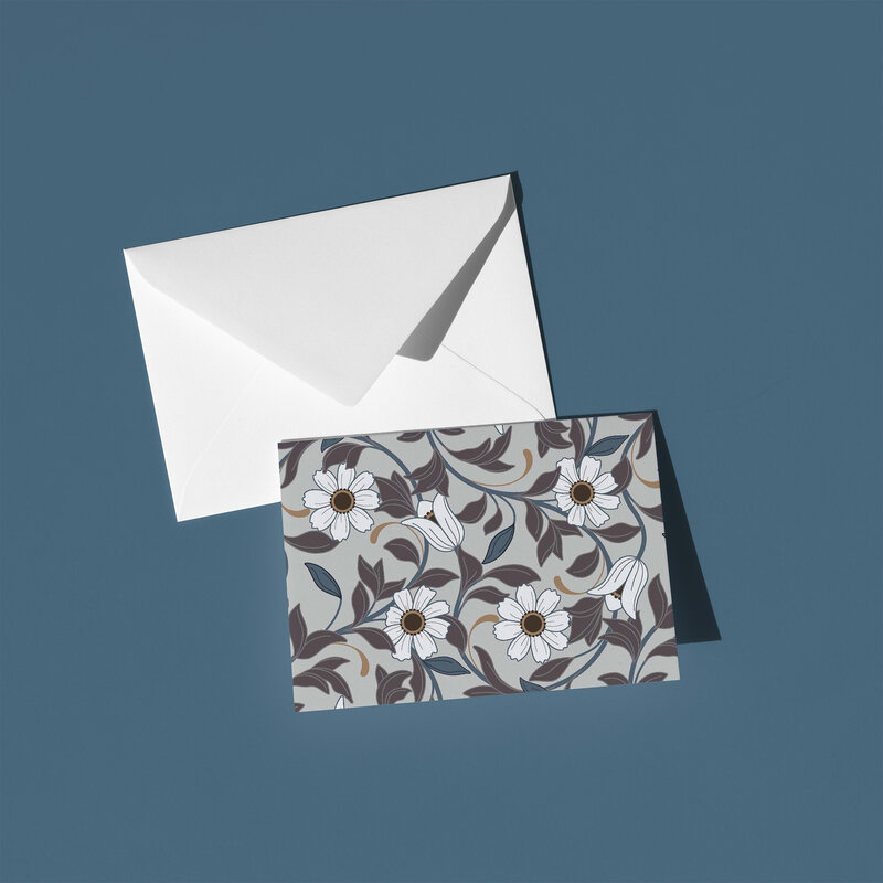 These A6 blank cards are perfect for sending a thoughtful note or simply keeping in your stationery drawer for special moments. Each card showcases a unique hand-drawn design - White art-deco flowers with purple and blue leaves on a beige putty background - by Green Acre Designs.