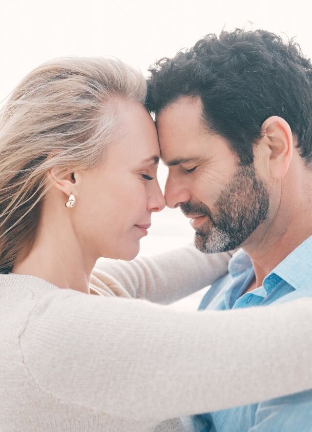 A couple hugging and looking in love. This can represent how couples in the aftermath of infidelity can reconnect and restore balance utilizing the roadmap to healing after infidelity inside the affair recovery coaching program by Relationship Experts