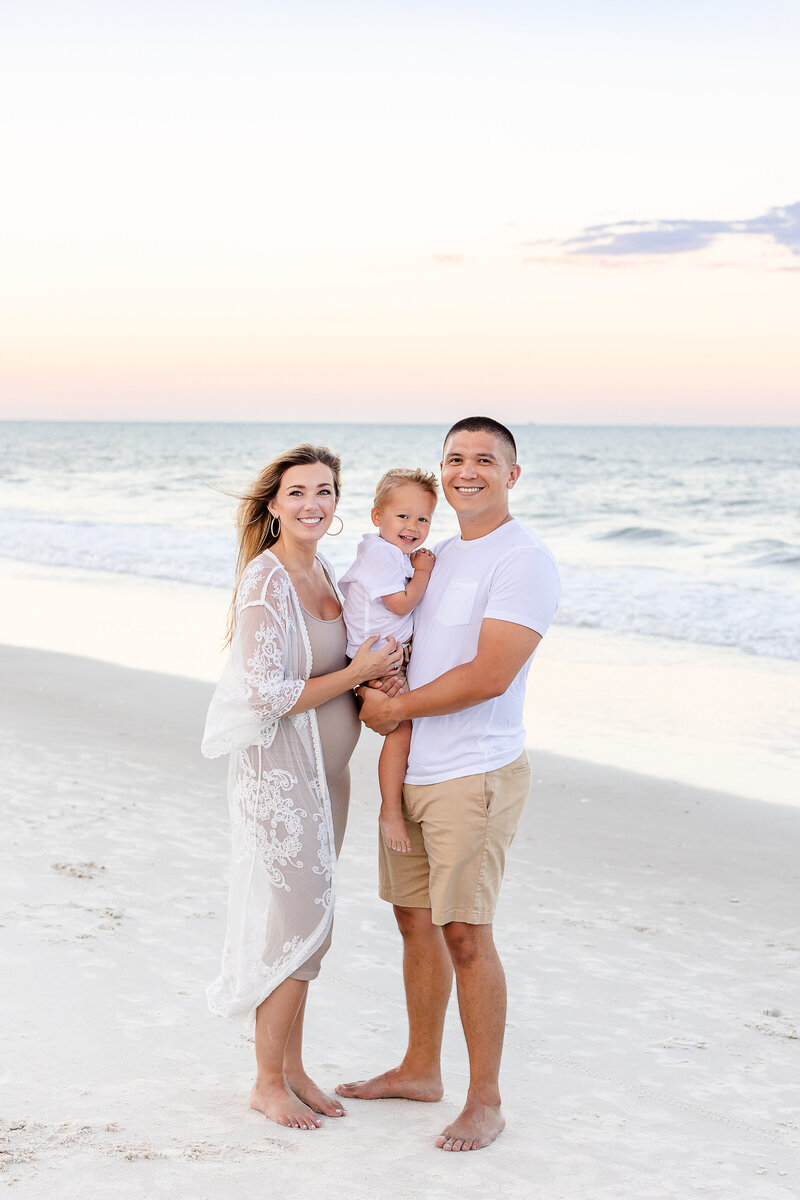 family of three on the beach in Virginia Beach, VA