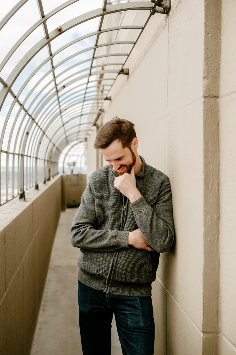 Natural lifestyle dating portrait of a Twin Cities single photographed in a Minneapolis walkway, showing relaxed, authentic dating profile imagery.
