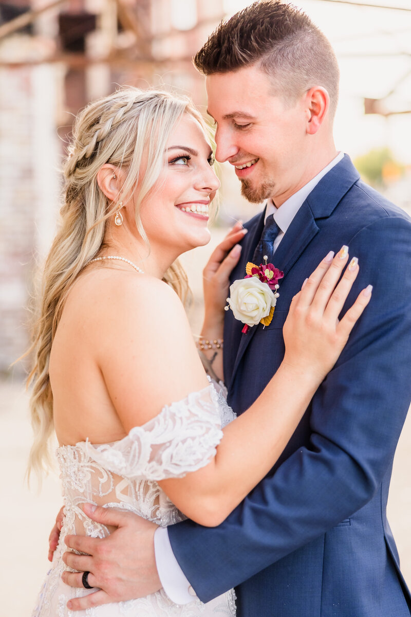 Bride and groom embrace at the Warehouse on State wedding venue in Peoria, Illinois.