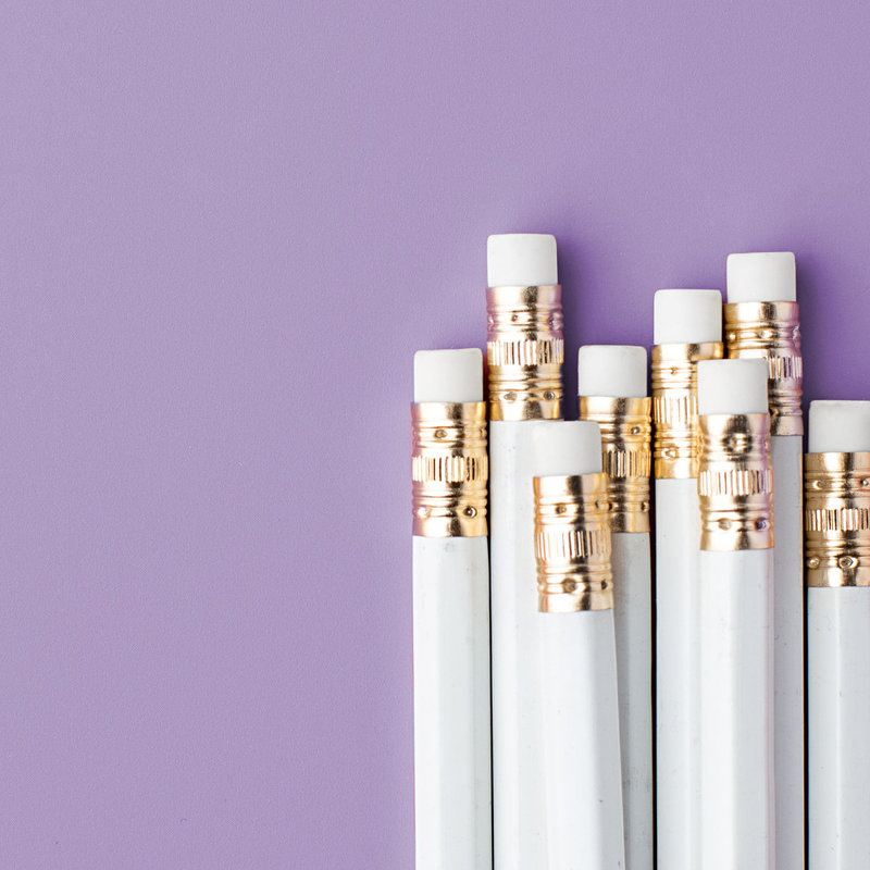 White pencils, purple background