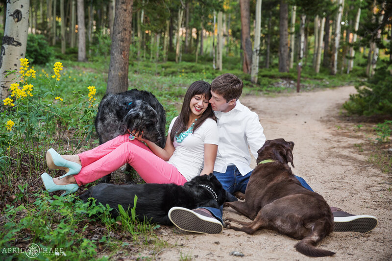 Cute engagement portrait with dogs along path at Golden Gate Canyon State Park