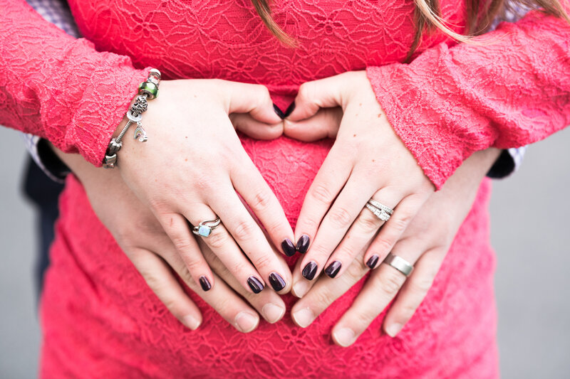 Maternity session close up of heart hands
