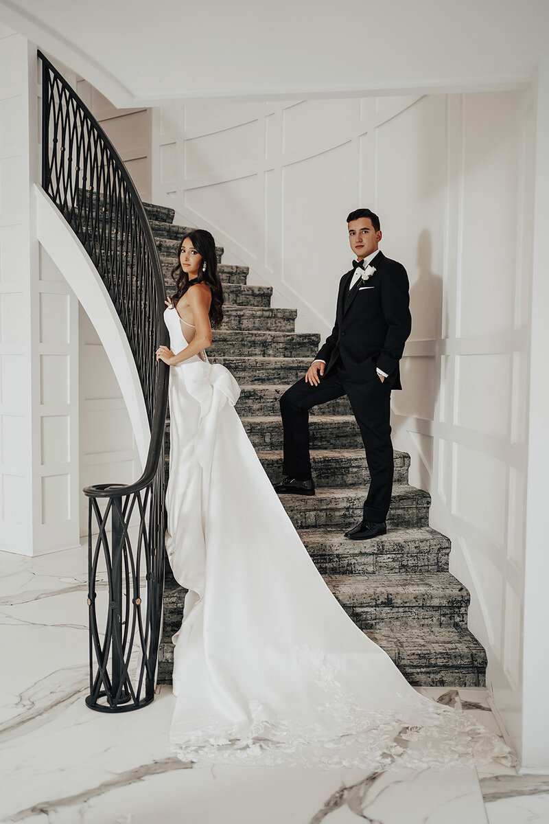 bride and groom posed on stairs