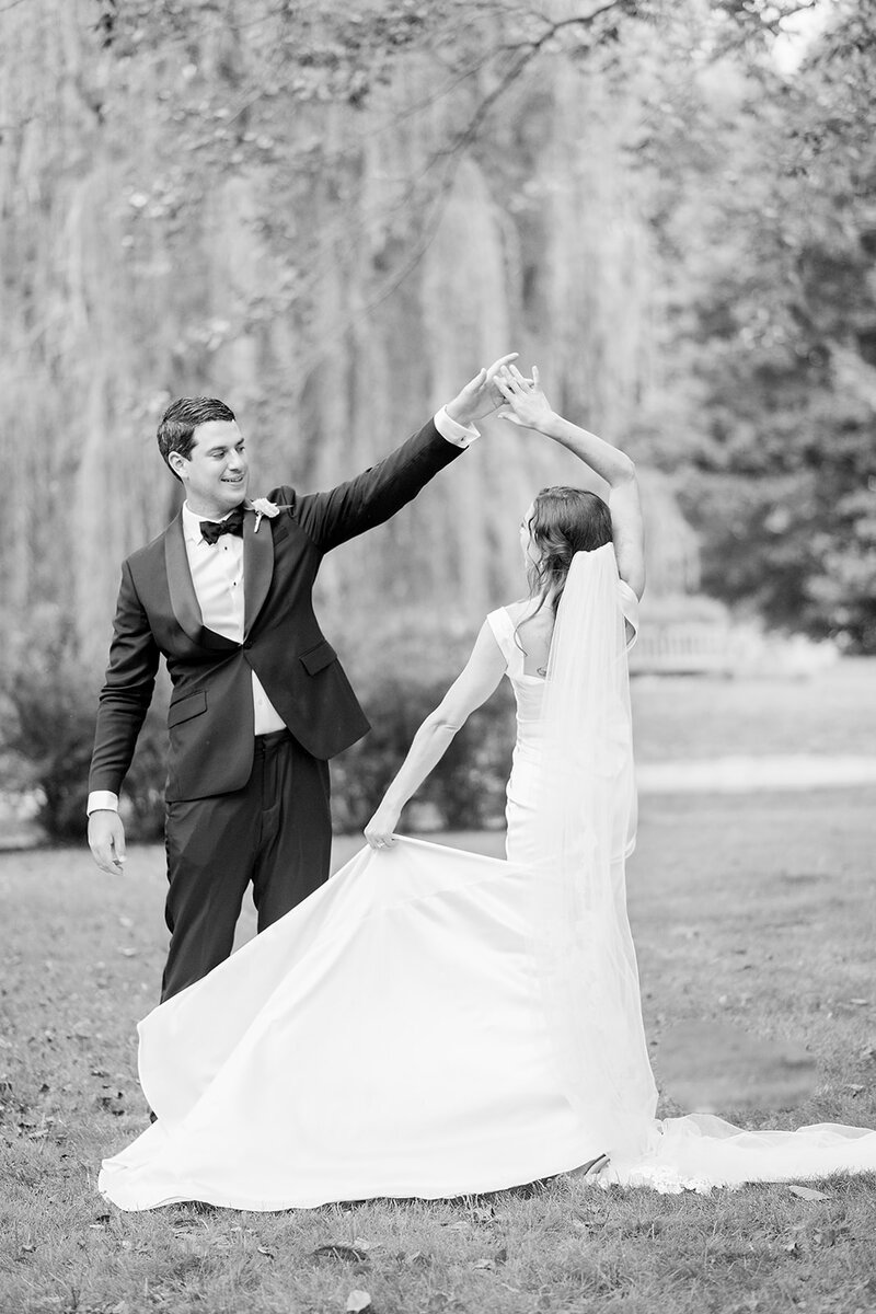 Groom giving the bride a twirl on their wedding day