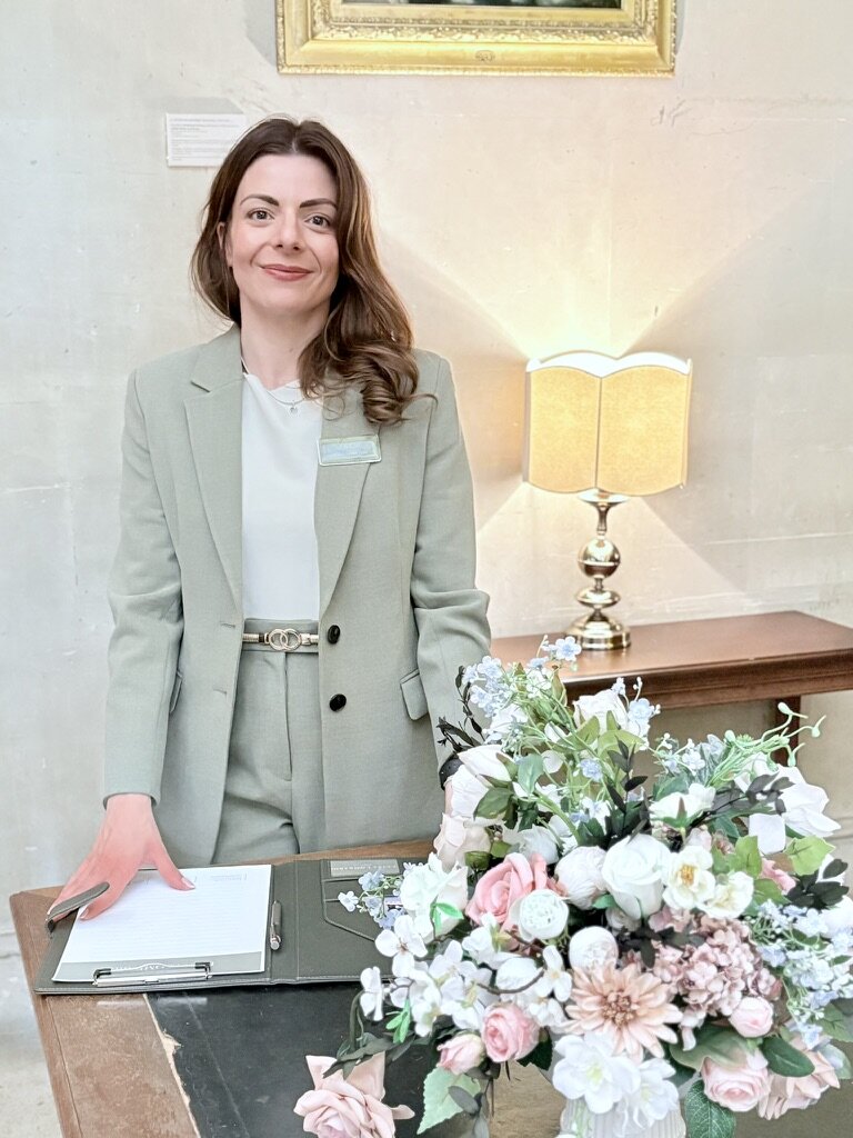 A bride shows off her blue and cream wedding bouquet at her winter wedding.