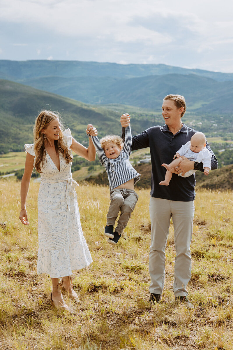 Playful moment of a family enjoying a summer day in Beaver Creek Colorado. Timeless cherished memories