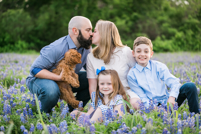 Family of four with their dog in field of bluebonnets, Austin Family Photographer