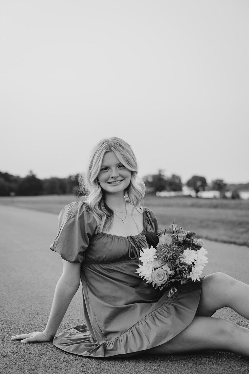 girl poses for senior photos in kansas city