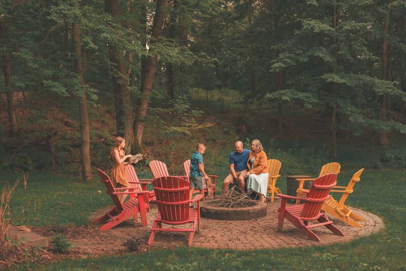 Candid family portrait of parents and children enjoying time together in their front yard in Minneapolis