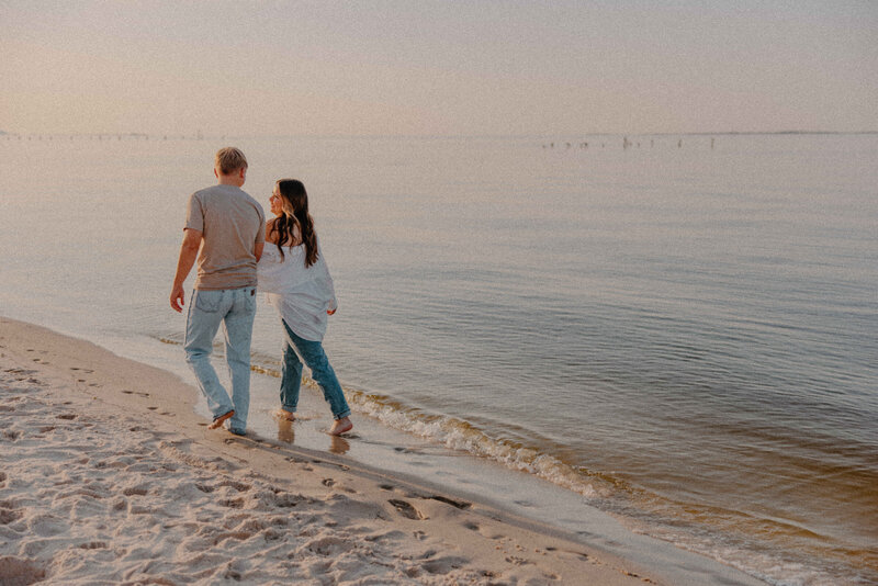 couple walking on the beach holding hands