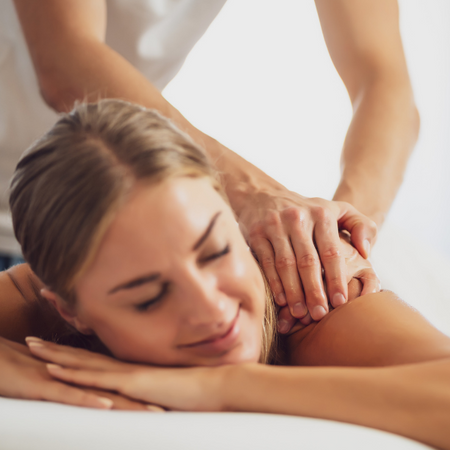Woman getting a massage in ritual chiropractic office