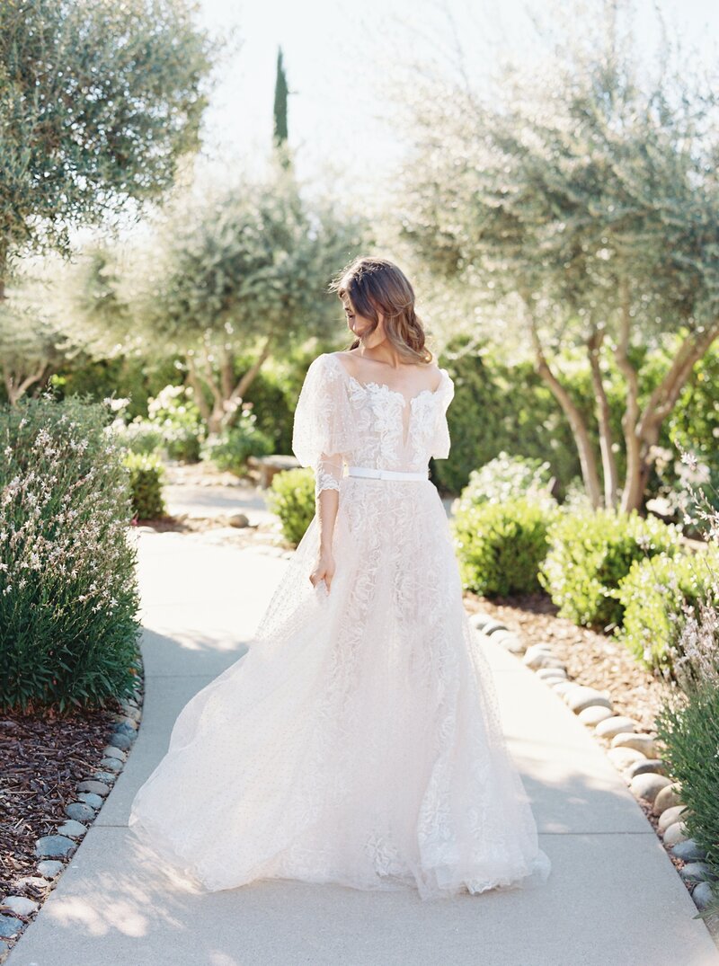 Beautiful bride in a flowy wedding dress with flower pattern