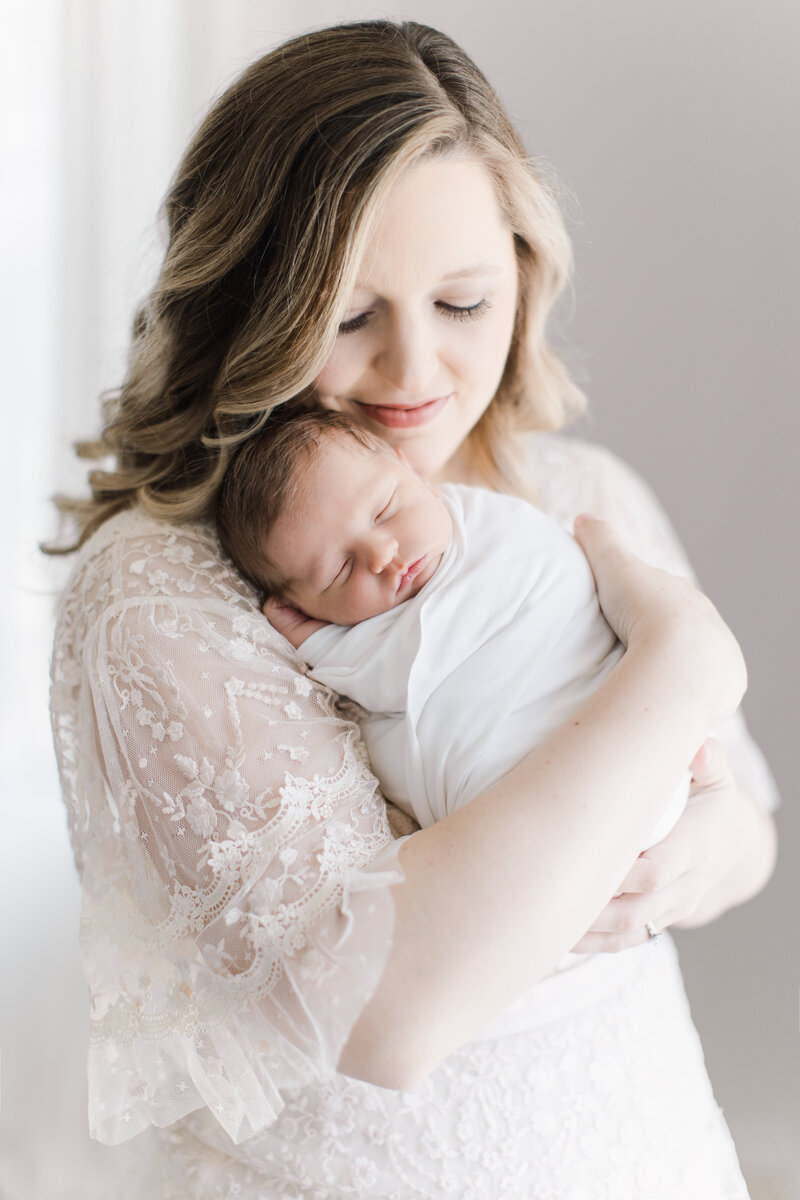 Romantic airy photo of mom with newborn.