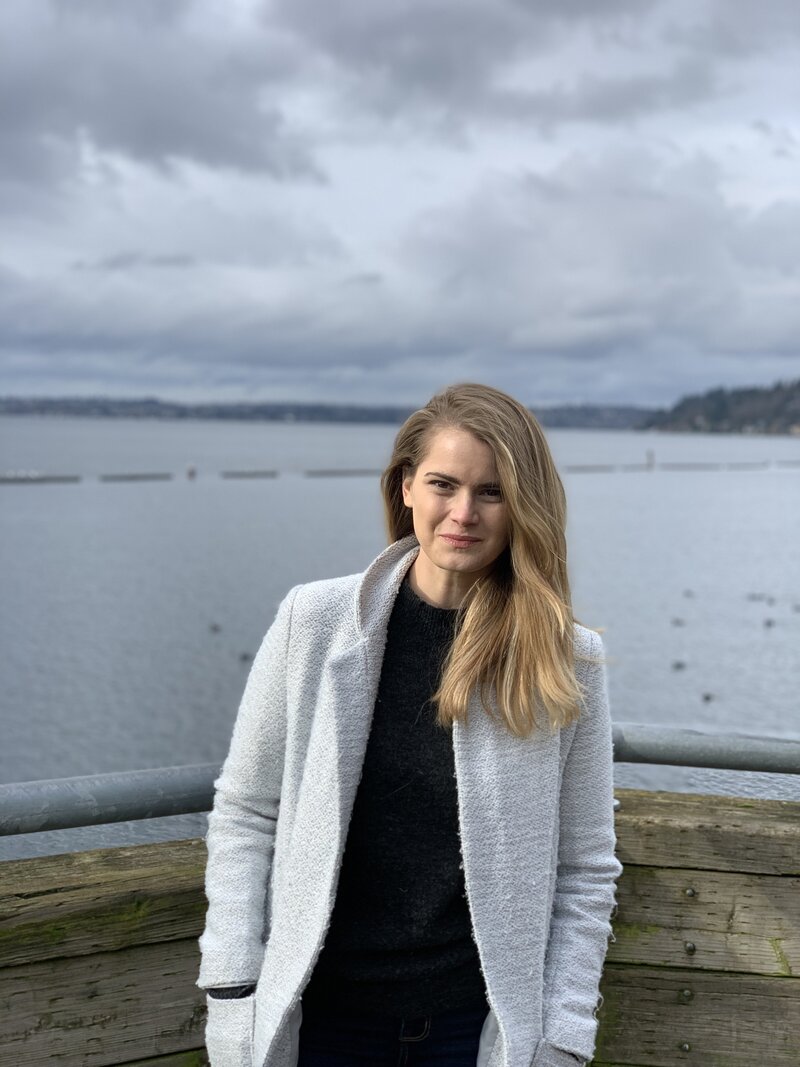 portrait of Dr. Caroline Antler, a disability-informed therapist with long, wavy blonde hair and gold-rimmed glasses. Her calm and confident expression reflects her approachable and compassionate nature, dedicated to supporting individuals with chronic illness and mental health challenges.