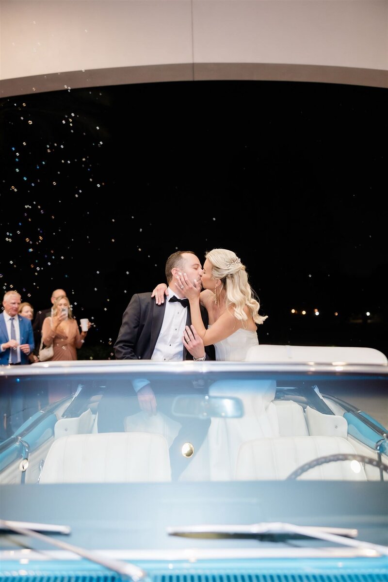 Wedding reception getaway car at the country club of Orlando by orlando wedding photographer 