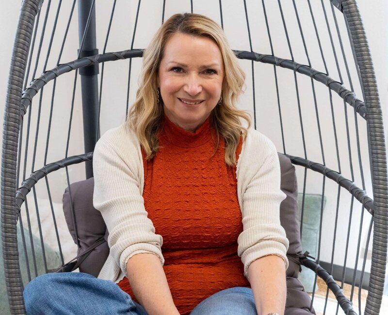 Francine-errico-must-writing-services-professional-grant-writer-sitting-in-chair-smiling