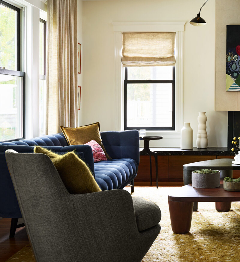 Historic home designer in Boston updates a Brookline home with modern furniture, blending original architecture with contemporary pieces.