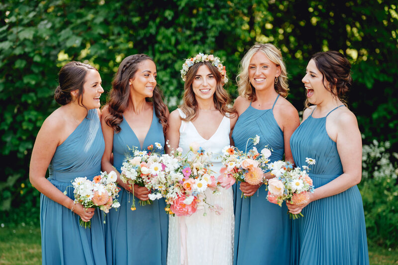Bride and bridesmaids wearing blue at Haybarn Dulus