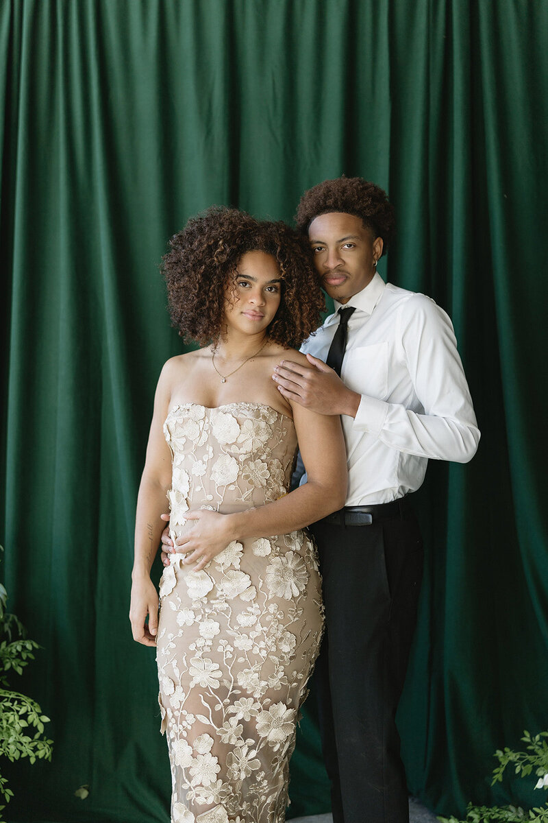 Couple posing in front of a print photo booth at their engagement in Ottawa.
