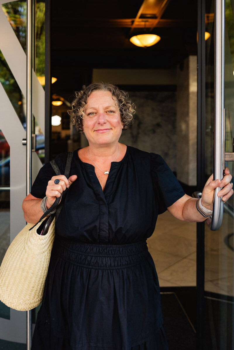 Cassie Peters, a business lawyer in Eugene, walks through a door and smiles