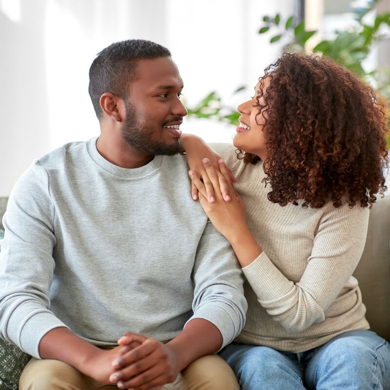 Couple sharing a warm moment during therapy, reflecting connection, trust, and emotional safety