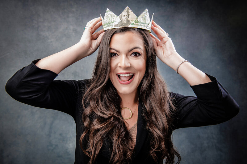 Financial wellness expert Anna wearing a crown of money