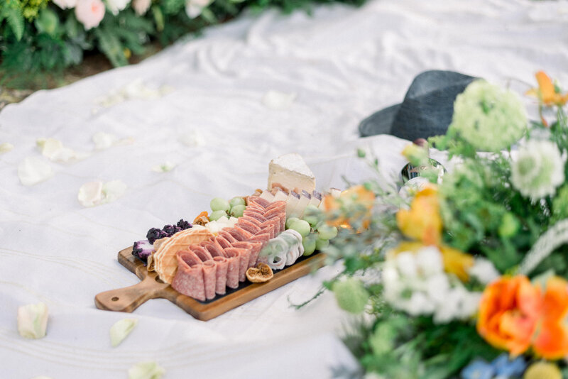 charcuterie board on a picnic blanket photographed on film at a Cypress Gardens elopement