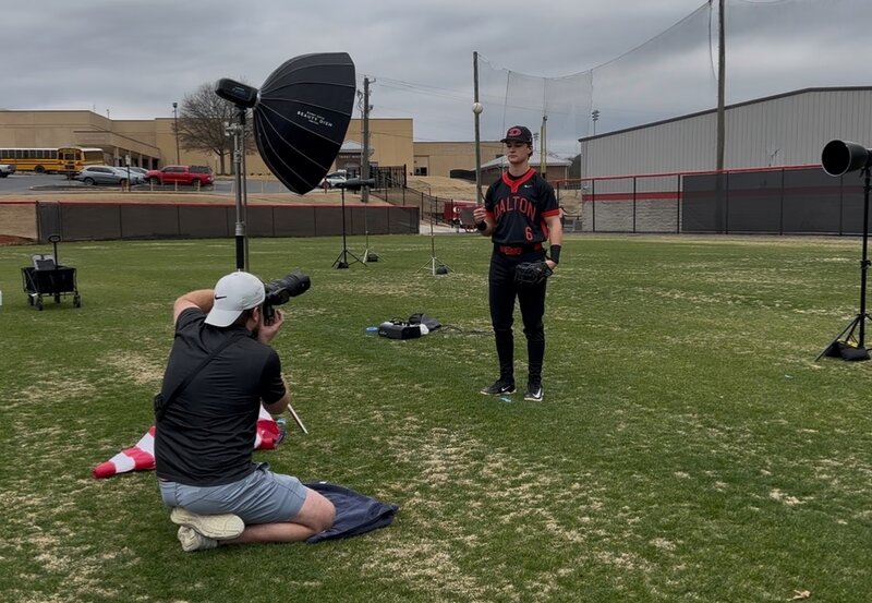 a sports photographer poses for a photo