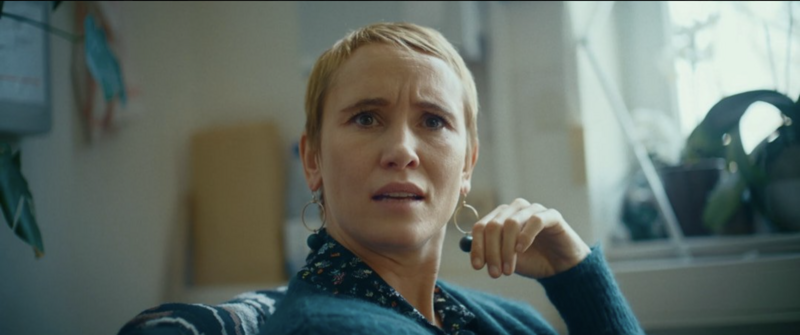 A raw confrontation between two characters in a dimly lit hallway.