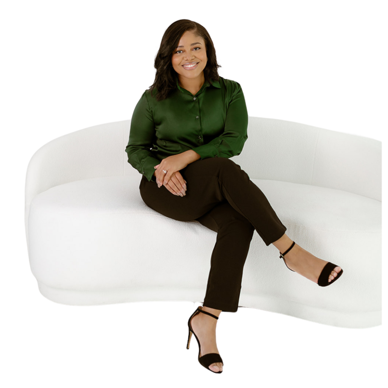 A smiling woman in a green blouse and black trousers sits elegantly on a curved white couch, with a soft green and lavender background.