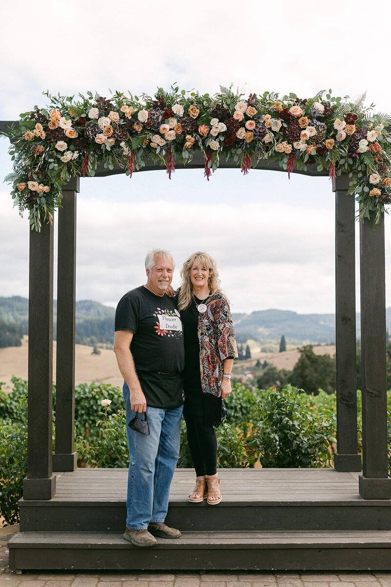 A wedding arch with a floral installation by Florist in Eugene Oregon, Flowers and Thyme.