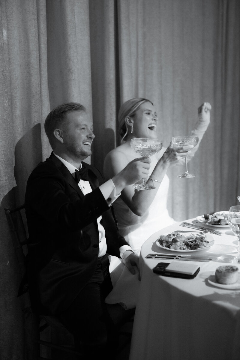 Bride and Groom cheering at wedding reception