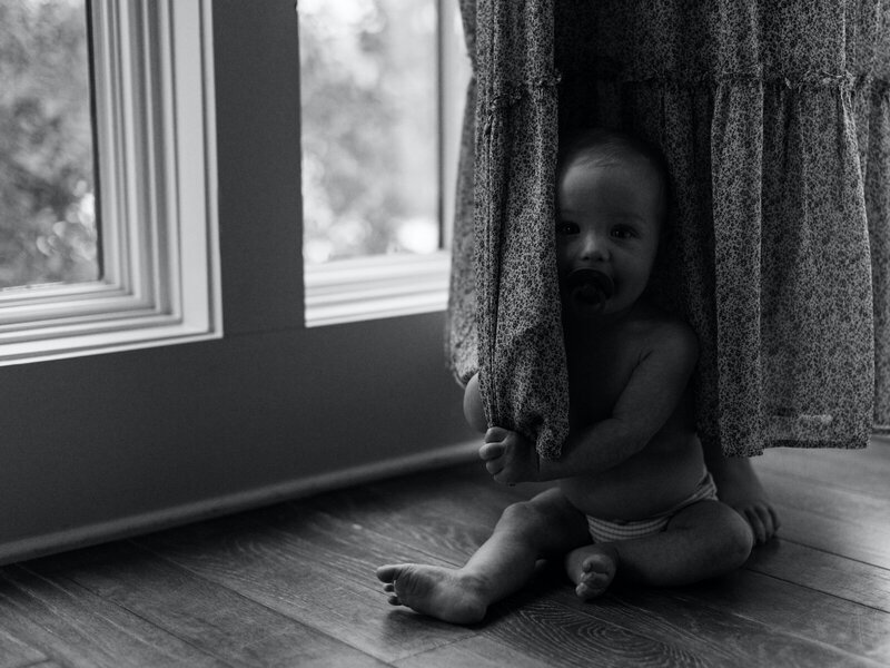 A baby boy hiding under his mother's dress in 30A.