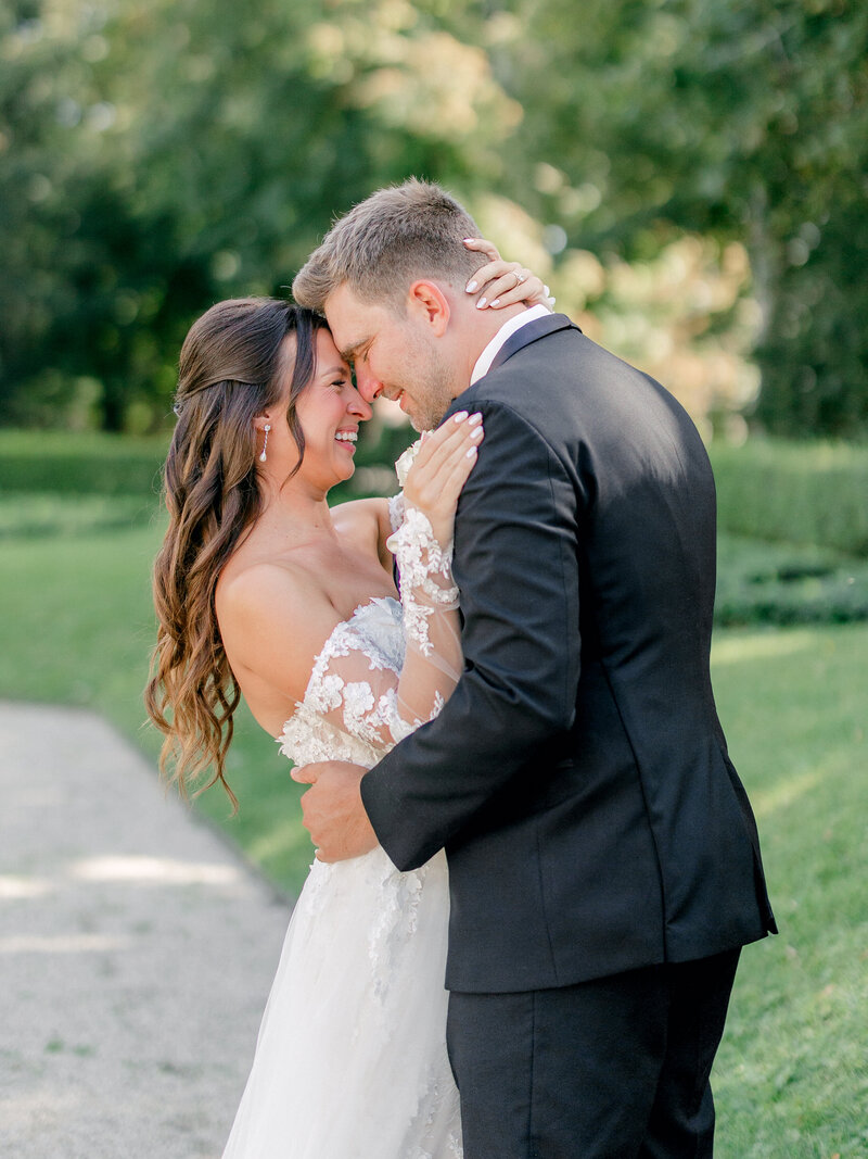 Bride pulls groom in for a kiss at her New England Newport destination wedding.