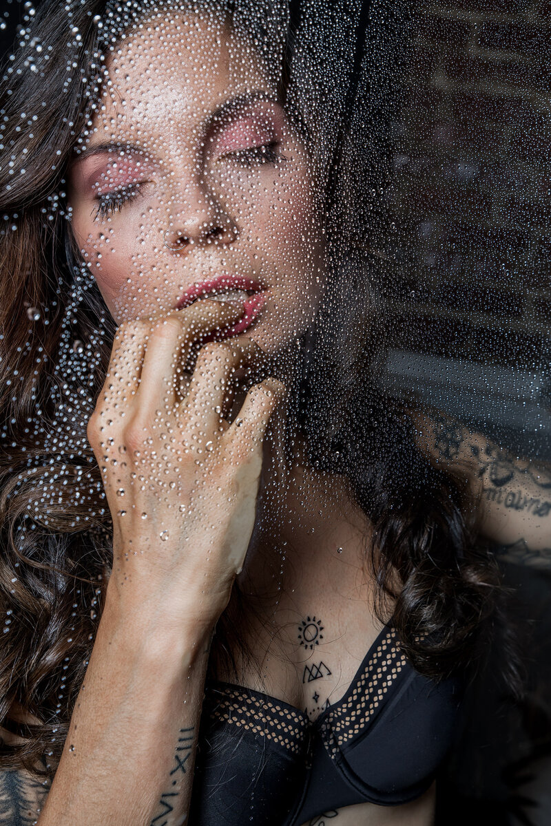 A woman standing in front of a window