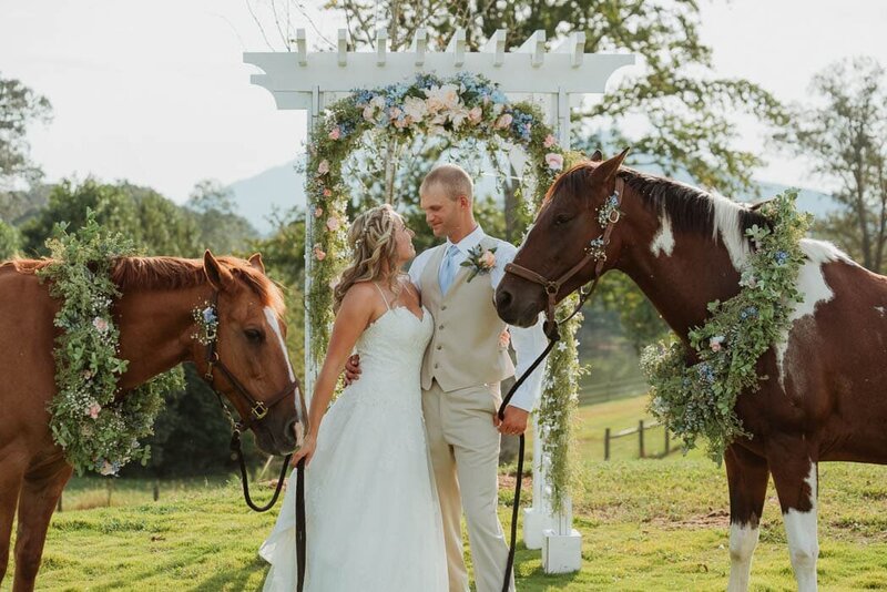 Newly weds posing with their horses