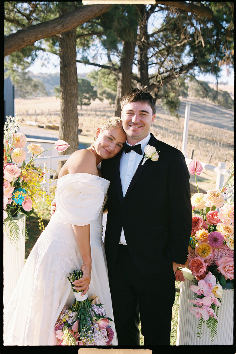 bride and groom laughing in positano on wedding day in a boat