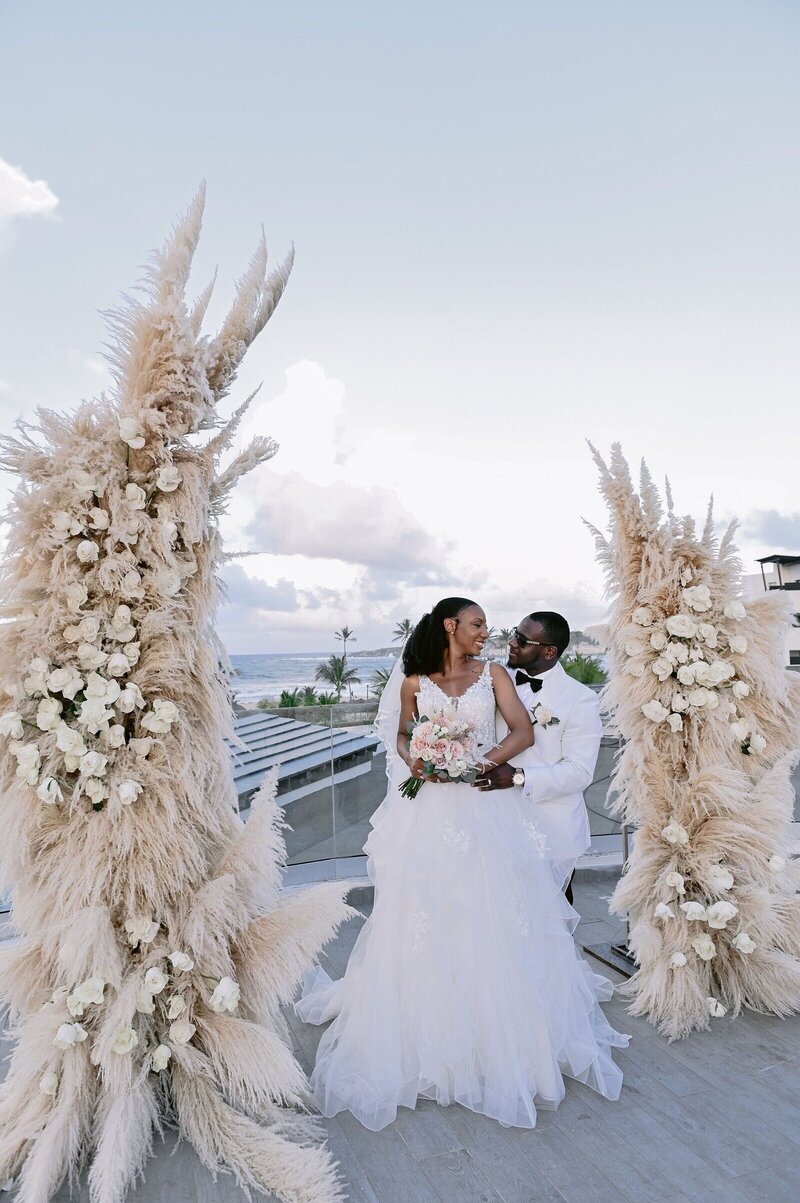 Couple kissing at ceremony by destination wedding travel planner CC Vacations
