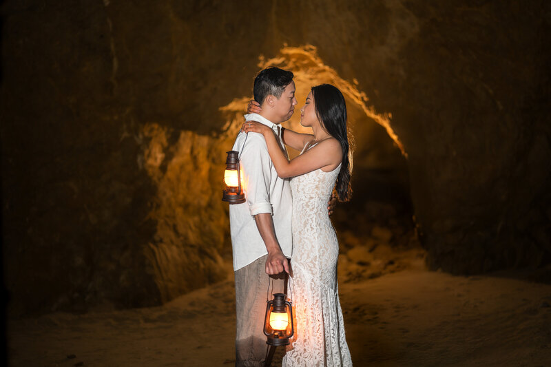 Bride and groom at the best place to elope in Malibu at El Matador Beach with cave and lanterns.