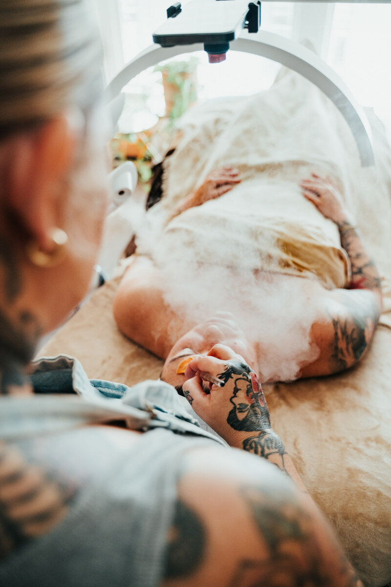 An over the shoulder shot caputing a client relaxed while they receive a facial by Libby in Eugene. 