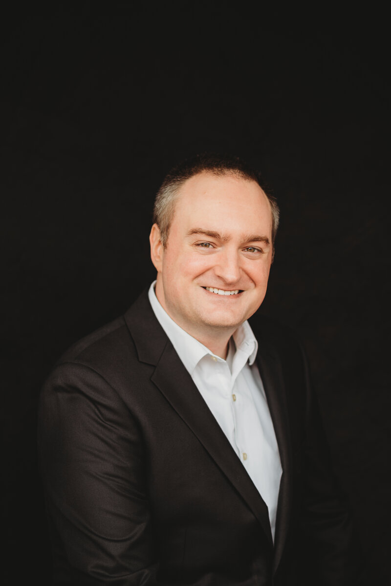 Polished professional headshot of an entrepreneur in Minneapolis, taken by Shannon O'Malley to enhance personal branding