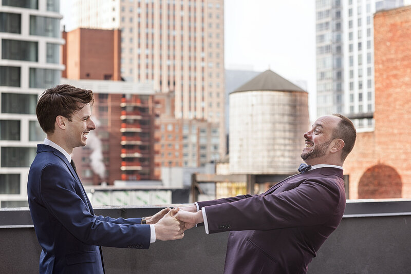 A couple dancing and smiling on a rooftop