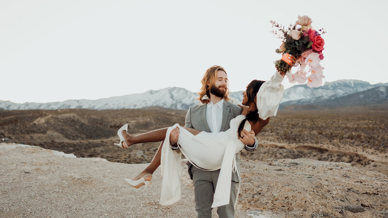 groom carries bride during elopement photo session