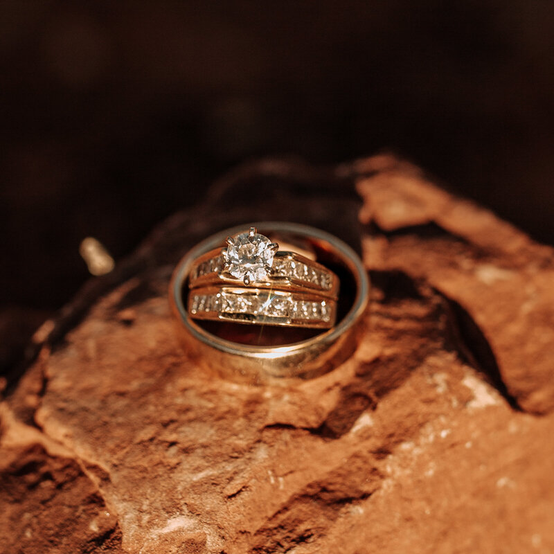 gold and diamond wedding rings on sedona red rock