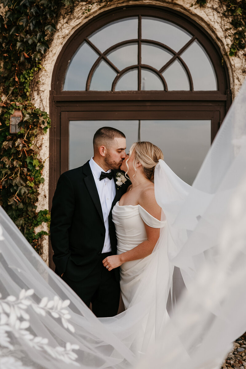 bride and groom with veil