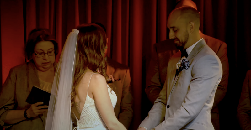 bride and groom holding hands while looking at each other