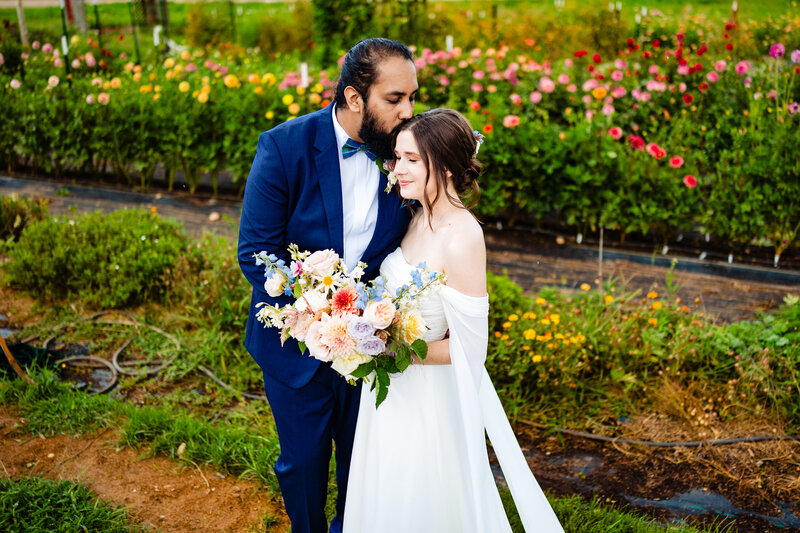 A wedding couple embracing in a flower garden in Detroit Michigan